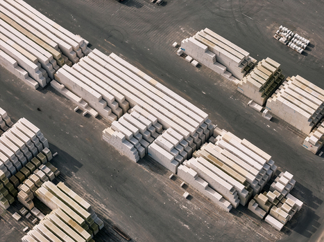 Aerial view of stacked concrete blocks in a storage yard with rows of construction materials on asphalt ground in Dulmen North Rhine Westphalia Germany. Aerial view of stacked concrete blocks in a storage yard with rows of construction materials on asphalt ground in Dulmen North Rhine Westphalia Germany.
