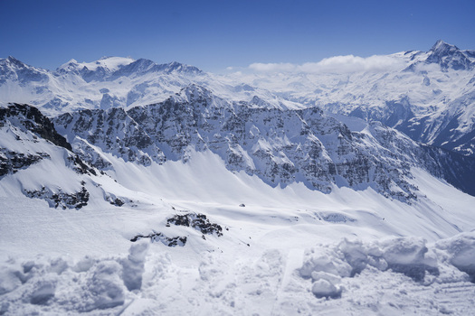 Aerial view of the snow covered peaks and rugged ridges of La Rosiere in the French Alps under a clear blue sky Montvalezan Auvergne Rhone Alpes France.