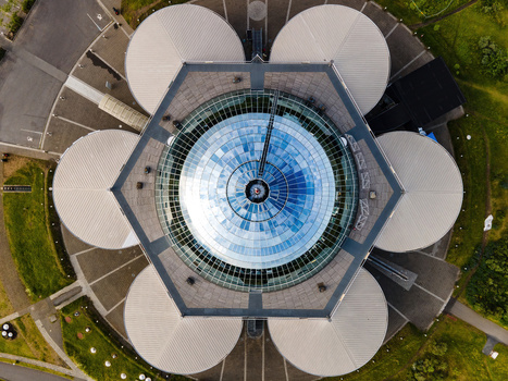 Aerial view of Perlan a distinctive landmark with its glass dome and surrounding water tanks set within the green landscape of Reykjavik Reykjavikurborg Iceland. Aerial view of Perlan a distinctive landmark with its glass dome and surrounding water tanks set within the green landscape of Reykjavik Reykjavikurborg Iceland.