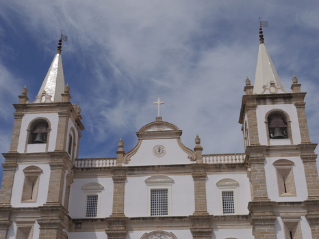 View of the facade of the Se de Portalegre cathedral with its two bell towers and white walls under a blue sky in Portalegre Portalegre District Portugal.