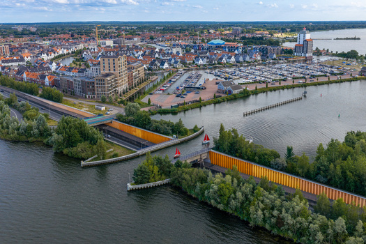 Aerial view of Aquaduct Veluwemeer showing the unique water bridge where boats sail over the road with the marina and town in Harderwijk Gelderland Netherlands.