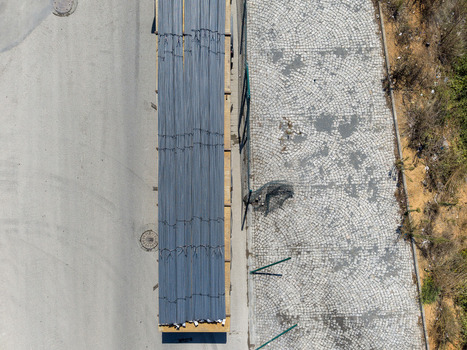 Aerial view of a truck loaded with steel bars on a wooden pallet parked on an asphalt road next to a cobblestone path in Istanbul Istanbul Turkey. Aerial view of a truck loaded with steel bars on a wooden pallet parked on an asphalt road next to a cobblestone path in Istanbul Istanbul Turkey.