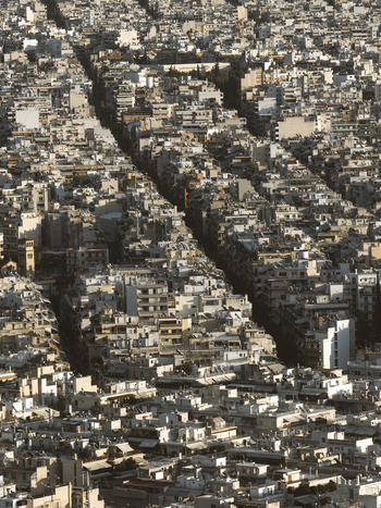 View of crowded urban landscape with residential buildings and city skyline Athens Greece.