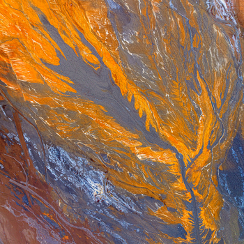 Aerial view of the vibrant orange and dark mineral rich river channels of the Rio Tinto landscape in Andalusia Spain. Aerial view of the vibrant orange and dark mineral rich river channels of the Rio Tinto landscape in Andalusia Spain.