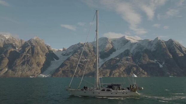 Aerial View of a sailing boat along the fjords in Sermersooq Greenland.