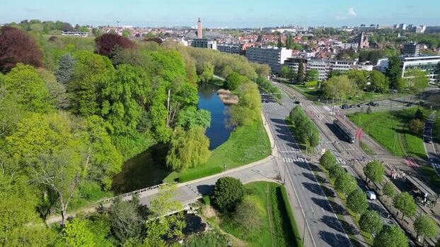 Aerial view of a lush park with a pond and tram tracks Belgium. Aerial view of a lush park with a pond and tram tracks Belgium.