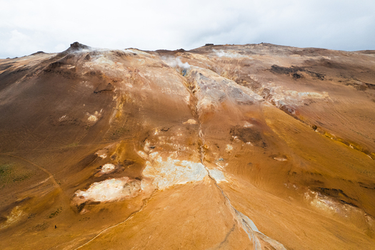 Aerial view of Hverir geothermal area with steaming fumaroles and colorful volcanic soil in Reykjahlid Thingeyjarsveit Iceland.