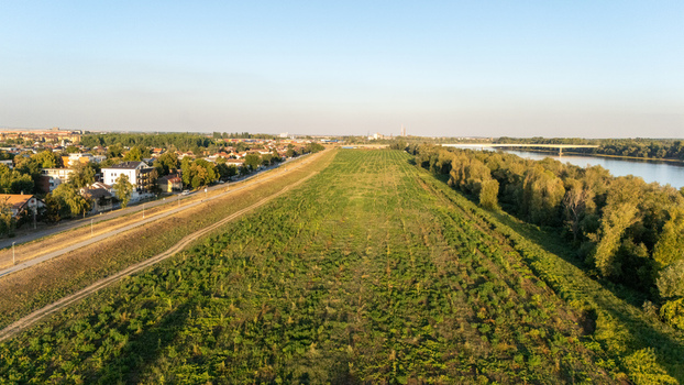 Aerial view of the Sava riverbank with green fields a riverside road and dense trees in Sremska Mitrovica Vojvodina Serbia. Aerial view of the Sava riverbank with green fields a riverside road and dense trees in Sremska Mitrovica Vojvodina Serbia.