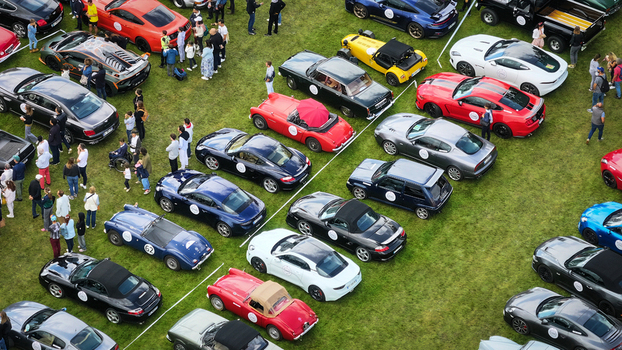 La Chapelle de Guinchay France 01 June 2024 Aerial view of a luxury and vintage car exhibition on a green field with people walking among the vehicles. La Chapelle de Guinchay France 01 June 2024 Aerial view of a luxury and vintage car exhibition on a green field with people walking among the vehicles.