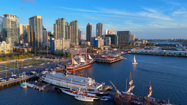Aerial view of the San Diego waterfront featuring the North Embarcadero historic tall ships the Berkeley ferryboat and the city skyline in San Diego California United States.