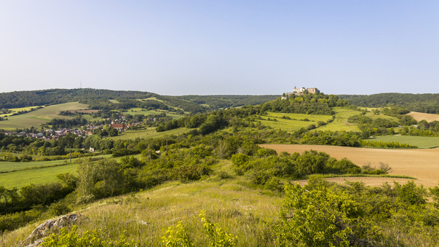 View of rolling hills and lush green fields meet the distant Falkenstein Castle under a vast sky a serene landscape Falkenstein Castle Lower Austria Austria. View of rolling hills and lush green fields meet the distant Falkenstein Castle under a vast sky a serene landscape Falkenstein Castle Lower Austria Austria.