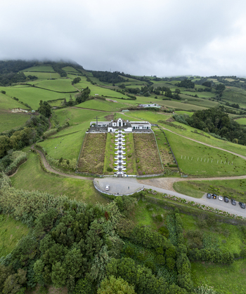 Aerial view of the Chapel of Nossa Senhora da Paz with its iconic long staircase set amidst lush green hills and rolling landscapes in Vila Franca Do Campo Acores Portugal. Aerial view of the Chapel of Nossa Senhora da Paz with its iconic long staircase set amidst lush green hills and rolling landscapes in Vila Franca Do Campo Acores Portugal.