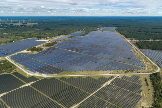 Aerial view of the former Preschen military airfield now a large scale solar farm with rows of photovoltaic panels and historic hangars Neisse Malxetal Brandenburg Germany. Aerial view of the former Preschen military airfield now a large scale solar farm with rows of photovoltaic panels and historic hangars Neisse Malxetal Brandenburg Germany.