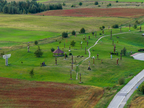 Aerial view of the Hill of Angels featuring wooden sculptures and a gazebo among green meadows and colorful fields in Traku rajonas Vilniaus apskritis Lithuania. Aerial view of the Hill of Angels featuring wooden sculptures and a gazebo among green meadows and colorful fields in Traku rajonas Vilniaus apskritis Lithuania.