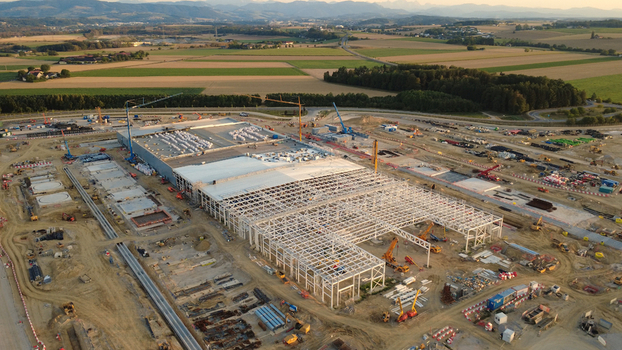 Aerial view of a data center construction site with steel framework cranes and heavy machinery in the countryside of Kronstorf Upper Austria Austria. Aerial view of a data center construction site with steel framework cranes and heavy machinery in the countryside of Kronstorf Upper Austria Austria.