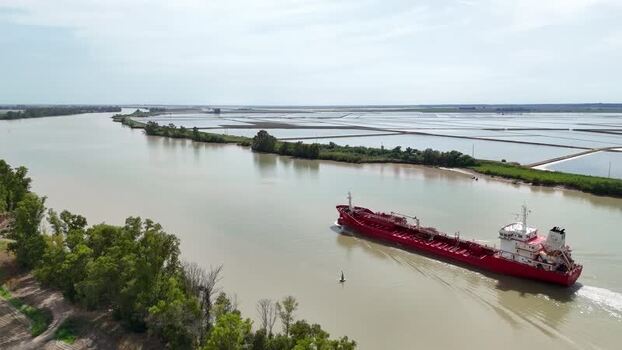 Aerial view of a red cargo ship on the Guadalquivir river Spain. Aerial view of a red cargo ship on the Guadalquivir river Spain.