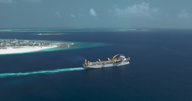 Aerial view of an industrial ship near a tropical island Maldives. Aerial view of an industrial ship near a tropical island Maldives.