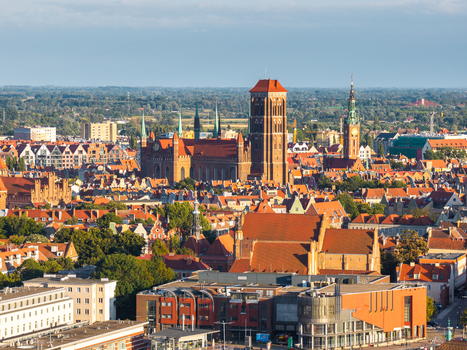Aerial view of St. Mary s Church and the historic city center with its characteristic red tiled rooftops and urban architecture in Gdansk Pomeranian Voivodeship Poland. Aerial view of St. Mary s Church and the historic city center with its characteristic red tiled rooftops and urban architecture in Gdansk Pomeranian Voivodeship Poland.
