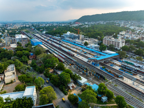 Aerial view of Udaipur Railway Station with multiple tracks passenger trains platforms and surrounding urban landscape in Udaipur Rajasthan India. Aerial view of Udaipur Railway Station with multiple tracks passenger trains platforms and surrounding urban landscape in Udaipur Rajasthan India.