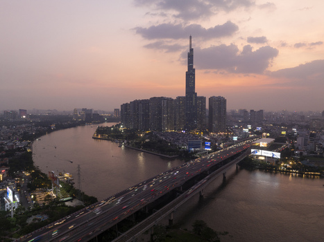 Aerial view of Landmark 81 skyscraper and the Saigon River at sunset with city lights and traffic on the bridge in Ho Chi Minh City Ho Chi Minh Vietnam. Aerial view of Landmark 81 skyscraper and the Saigon River at sunset with city lights and traffic on the bridge in Ho Chi Minh City Ho Chi Minh Vietnam.