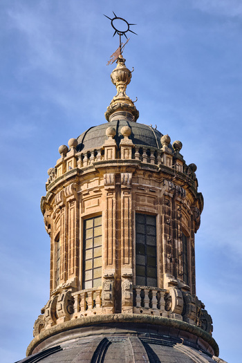 Salamanca Spain 01 December 2025 View of the ornate baroque dome and weather vane of the Pontifical University of Salamanca under a clear blue sky. Salamanca Spain 01 December 2025 View of the ornate baroque dome and weather vane of the Pontifical University of Salamanca under a clear blue sky.