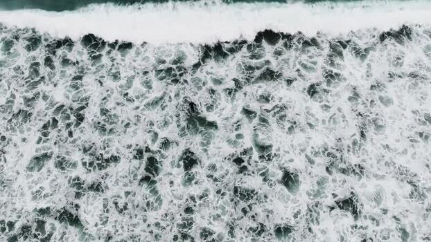 Aerial view of surfer in ocean waves New Zealand. Aerial view of surfer in ocean waves New Zealand.