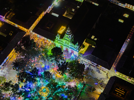 Aerial view of a brightly lit plaza and surrounding buildings glowing in the night with vibrant Christmas lights Salamina Caldas Colombia. Aerial view of a brightly lit plaza and surrounding buildings glowing in the night with vibrant Christmas lights Salamina Caldas Colombia.