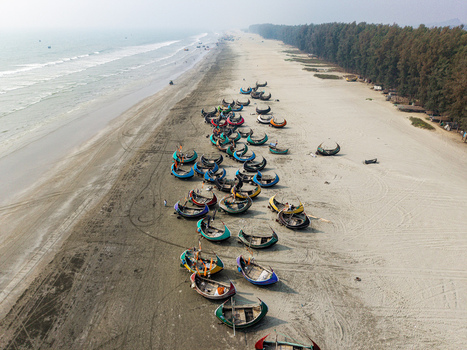 Cox s Bazar Bangladesh 10 March 2026 Aerial view of traditional colorful moon boats parked on the sandy shore of the world s longest natural sea beach under a hazy sky. Cox s Bazar Bangladesh 10 March 2026 Aerial view of traditional colorful moon boats parked on the sandy shore of the world s longest natural sea beach under a hazy sky.