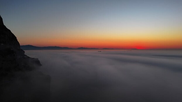 Aerial view of Europa Point at sunset with thick fog Gibraltar.