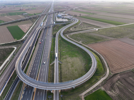 Aerial view of the Autostrada Torino Milano interchange with its curved ramps and surrounding agricultural fields in Borgo d Ale Piedmont Italy. Aerial view of the Autostrada Torino Milano interchange with its curved ramps and surrounding agricultural fields in Borgo d Ale Piedmont Italy.