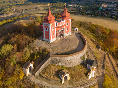 Aerial view of the historic Stiavnicka kalvaria pilgrimage site with its red roofed church and stone walls atop a hill in Banska Stiavnica Banskobystricky kraj Slovakia. Aerial view of the historic Stiavnicka kalvaria pilgrimage site with its red roofed church and stone walls atop a hill in Banska Stiavnica Banskobystricky kraj Slovakia.