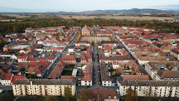 Aerial view of the Vauban walled city featuring its characteristic grid layout historic red tiled rooftops and central square in Neuf Brisach Grand Est France. Aerial view of the Vauban walled city featuring its characteristic grid layout historic red tiled rooftops and central square in Neuf Brisach Grand Est France.
