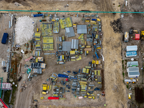 Aerial view of the construction site at the Heizkraftwerk Reuter West power plant with organized stacks of building materials formwork panels and containers in Berlin Berlin Germany.