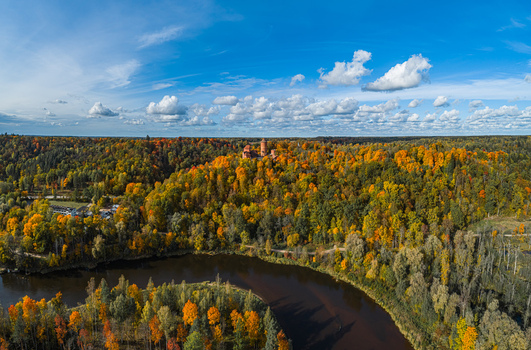 Aerial view of the historic Turaida Castle surrounded by vibrant autumn forests and the winding Gauja River in Sigulda Sigulda Municipality Latvia. Aerial view of the historic Turaida Castle surrounded by vibrant autumn forests and the winding Gauja River in Sigulda Sigulda Municipality Latvia.