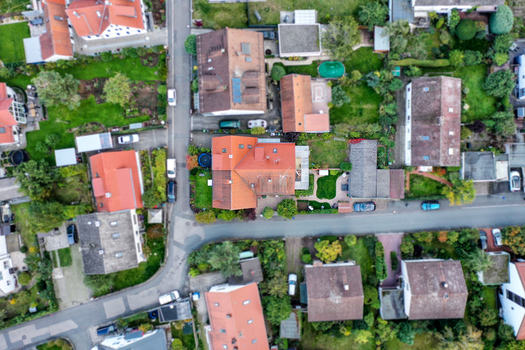 Aerial view of residential houses with red tiled roofs lush green gardens and quiet streets in Erlangen Bavaria Germany. Aerial view of residential houses with red tiled roofs lush green gardens and quiet streets in Erlangen Bavaria Germany.