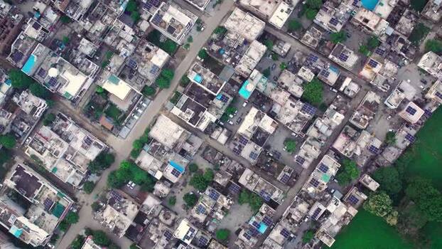 Aerial view of solar panels on residential rooftops India.