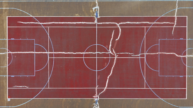 Aerial view of the Brzece Sports Centar basketball court featuring a red surface with prominent cracks in Brzece Rasina District Serbia.