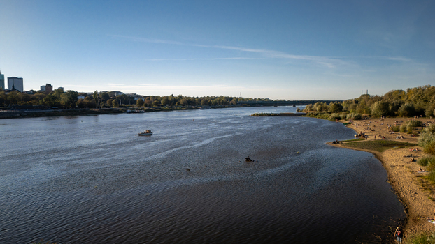 Aerial view of the Vistula River reflecting the clear sky contrasting with the sandy beach and the distant city skyline Warsaw Poland. Aerial view of the Vistula River reflecting the clear sky contrasting with the sandy beach and the distant city skyline Warsaw Poland.