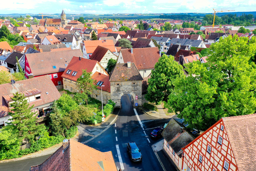 Aerial view of the historic town gate and traditional half timbered houses with red tiled rooftops in Neunkirchen am Brand Bavaria Germany. Aerial view of the historic town gate and traditional half timbered houses with red tiled rooftops in Neunkirchen am Brand Bavaria Germany.