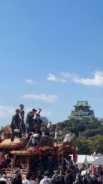 View of a festival float with Osaka Castle in the background Japan.
