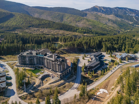 Aerial view of DAMIAN JASNA Hotel Resort and Residences nestled among lush pine forests and rolling mountain peaks in Demanovska Dolina Zilinsky kraj Slovakia. Aerial view of DAMIAN JASNA Hotel Resort and Residences nestled among lush pine forests and rolling mountain peaks in Demanovska Dolina Zilinsky kraj Slovakia.