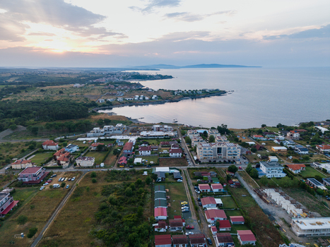 Aerial view of the coastal area of Arapya with residential buildings green fields and the Black Sea at sunset in Burgas Bulgaria. Aerial view of the coastal area of Arapya with residential buildings green fields and the Black Sea at sunset in Burgas Bulgaria.