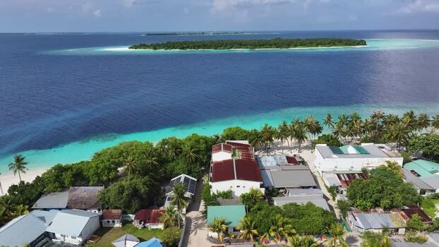 Aerial view of the tropical island of Maalhos in the Maldives. Aerial view of the tropical island of Maalhos in the Maldives.
