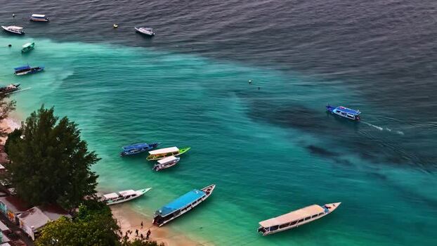 Aerial view of boats in the turquoise waters of Bali Indonesia.