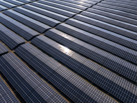 Aerial view of a large scale solar farm with rows of photovoltaic panels reflecting sunlight in the landscape of Lovech Lovech Bulgaria. Aerial view of a large scale solar farm with rows of photovoltaic panels reflecting sunlight in the landscape of Lovech Lovech Bulgaria.