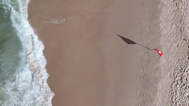 Aerial view of Copacabana Beach with waves and a red flag Brazil.