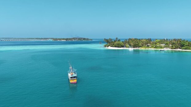 Aerial view of a Sri Lankan boat on turquoise water in Maldives. Aerial view of a Sri Lankan boat on turquoise water in Maldives.