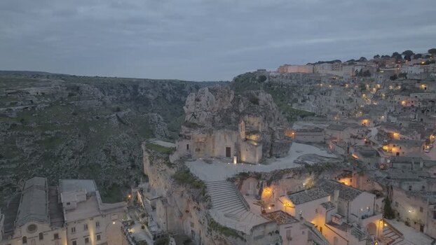 Aerial view of Sassi di Matera stone buildings at dusk Italy.