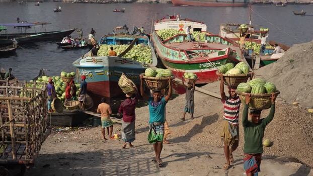 View of workers carrying watermelons at Sadarghat Bangladesh.