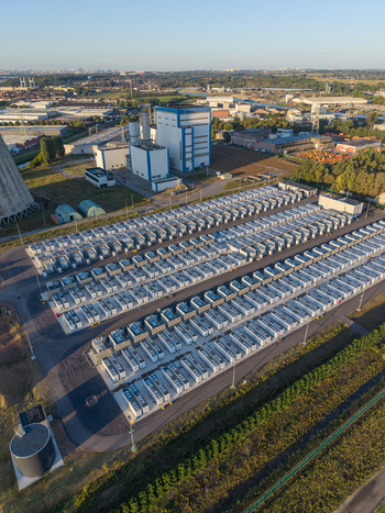 Aerial view of the Cargovil battery energy storage system with rows of energy storage containers industrial buildings and cooling towers in Vilvoorde Vlaanderen Belgium. Aerial view of the Cargovil battery energy storage system with rows of energy storage containers industrial buildings and cooling towers in Vilvoorde Vlaanderen Belgium.
